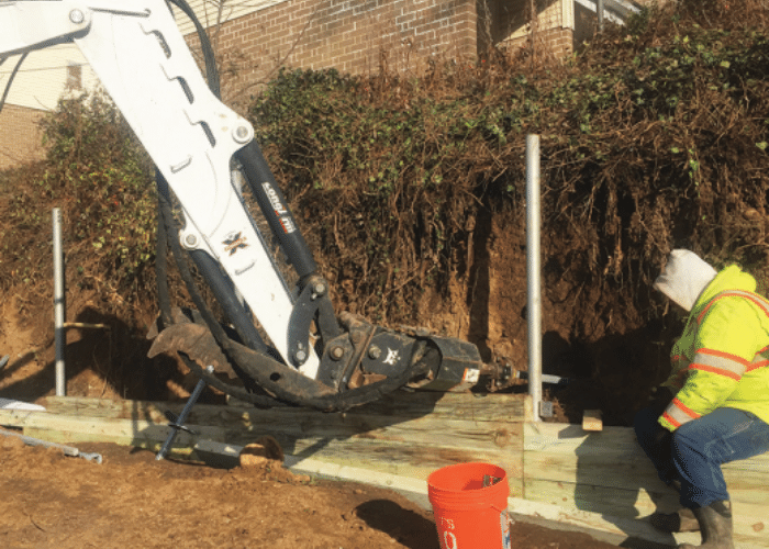 Midwest Foundation Tech completing a retaining wall using helical piers and helical tiebacks.