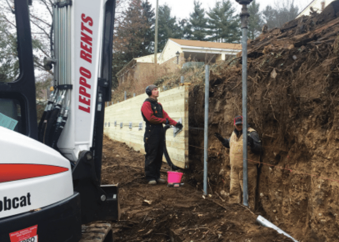 Midwest Foundation Tech completing a retaining wall using helical piers and helical tiebacks.